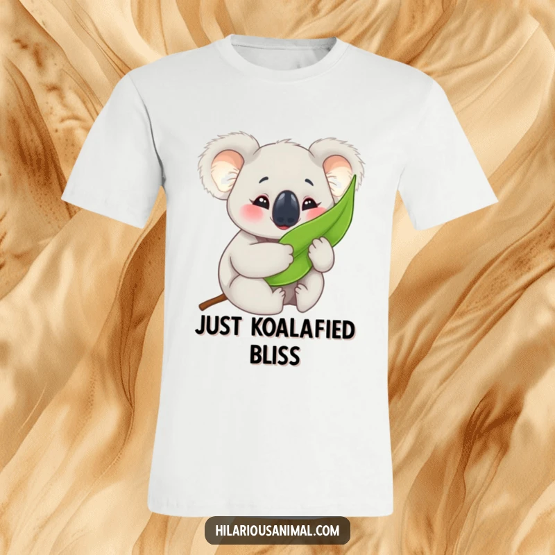 Funny koala cub t-shirt, hugging a eucalyptus leaf with eyes crinkled in happiness, perfect for casual comfort and smiles.