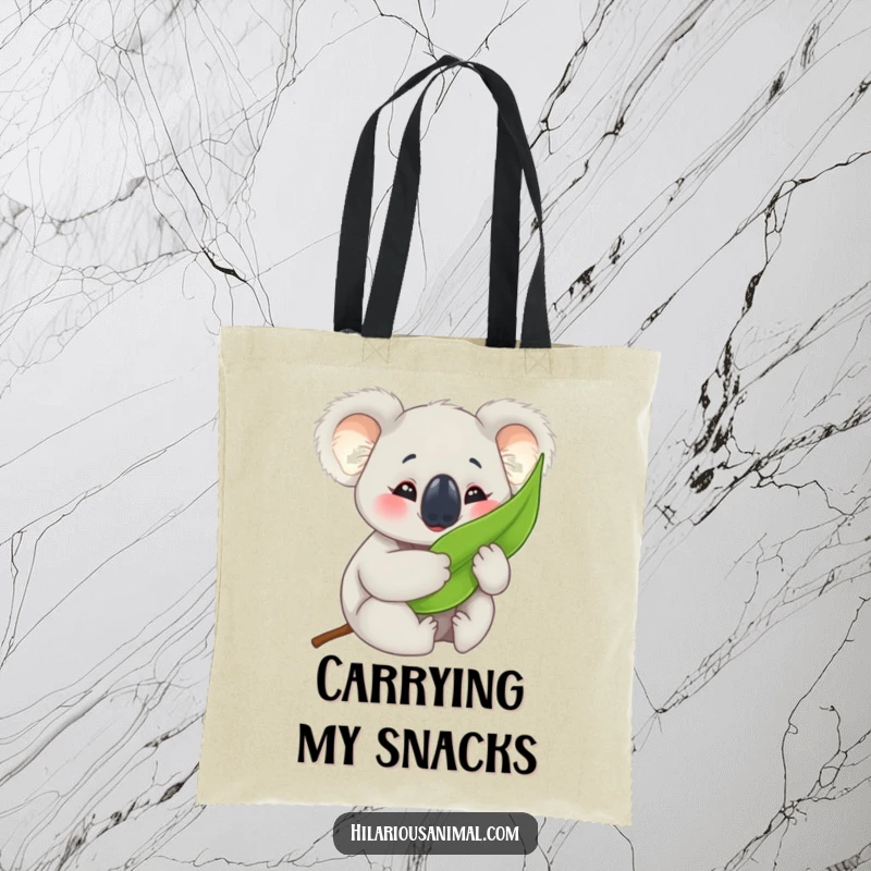 Funny koala cub tote bag, happily hugging a eucalyptus leaf with crinkled eyes, perfect for carrying essentials with charm.
